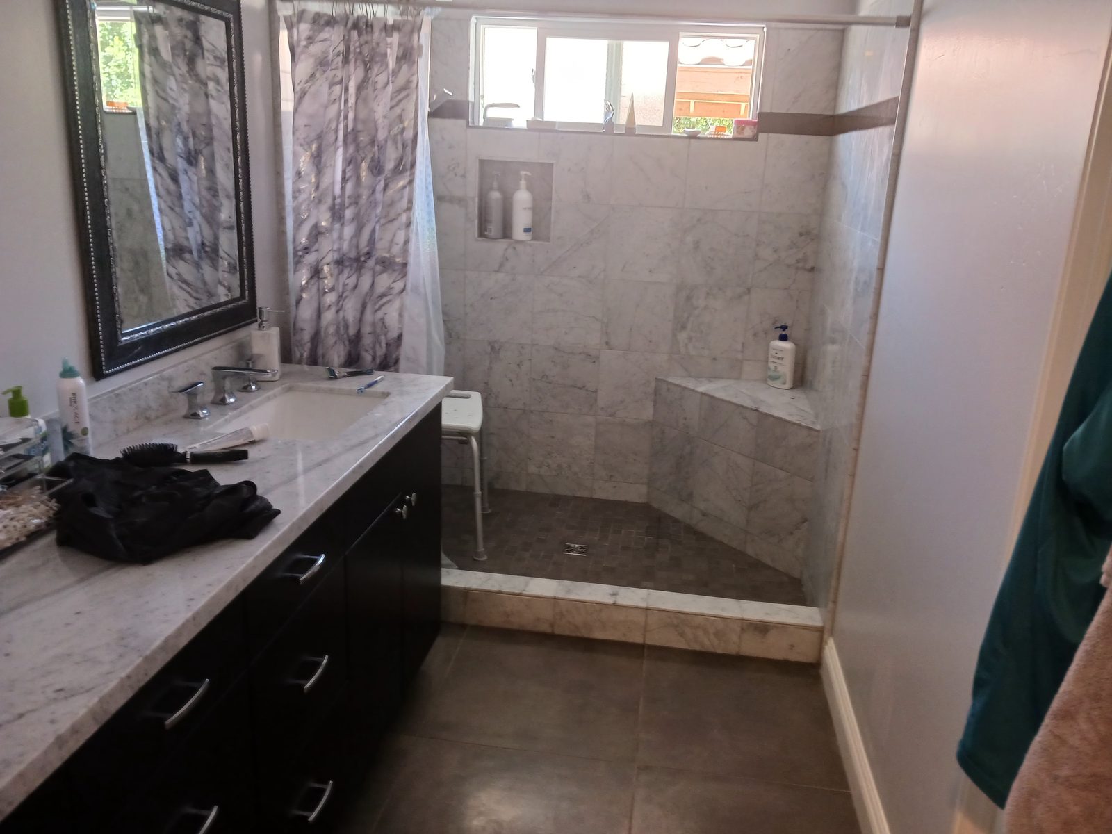 Walk-in curbless shower with built-in bench