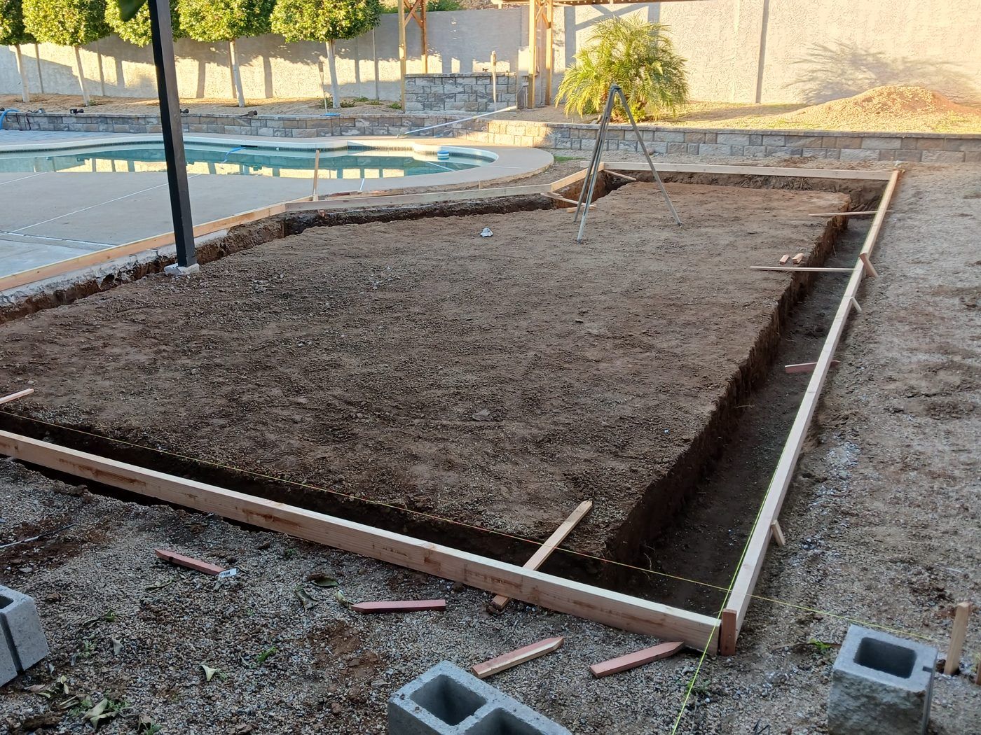 Squared foundation forms and excavation for a backyard structure